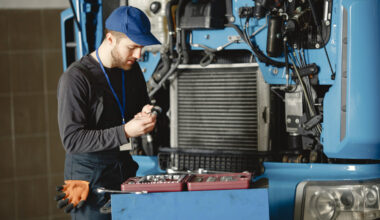 a man repairing a truck engine